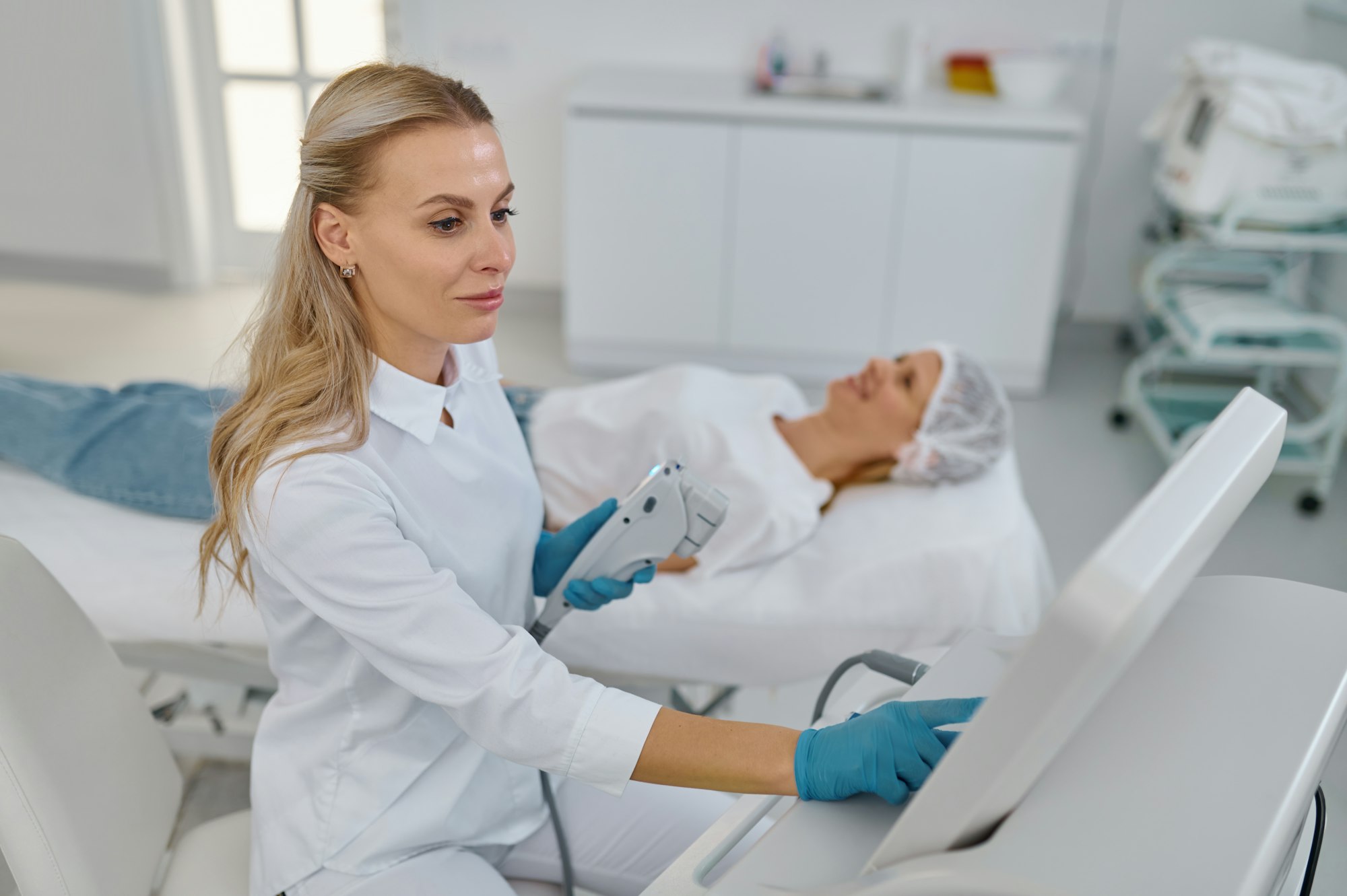 Portrait of young cosmetologist holding equipment for laser hair removal