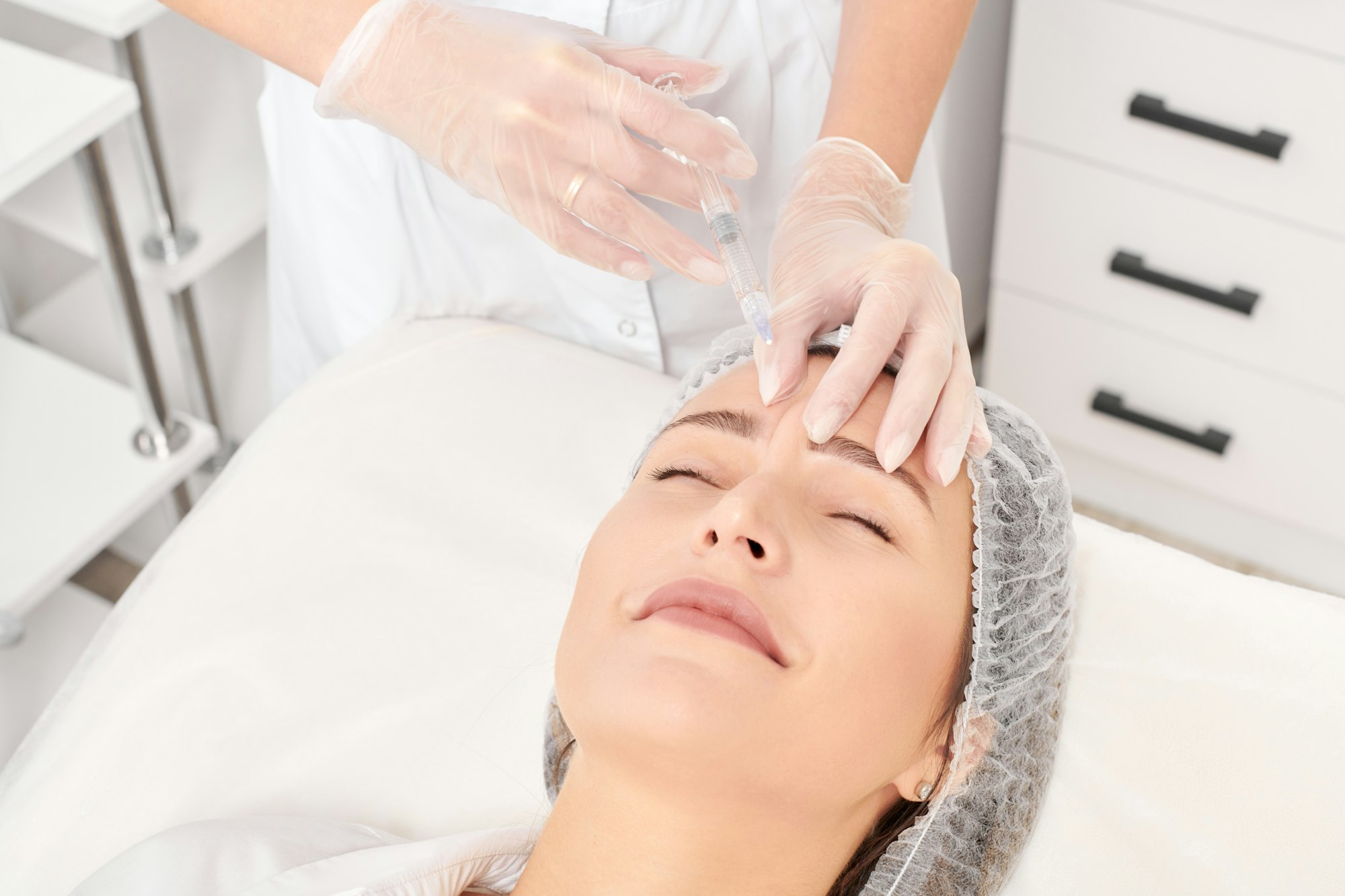 cosmetologist-makes-rejuvenation-injection-in-woman-face-anti-aging-procedure-in-beauty-salon