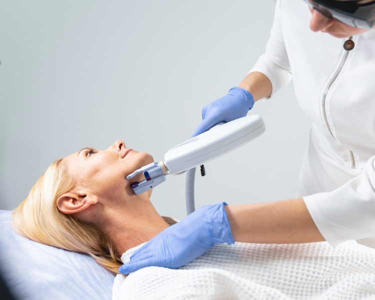 concentrated-female-cosmetologist-performing-the-laser-treatment-e1693297351297.jpg